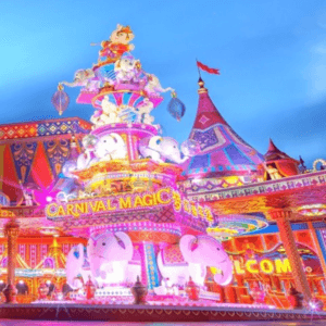 Carnival magic show: A vibrant night scene at Carnival Magic in Phuket, showcasing colourful lights, decorative elephants, and a festive atmosphere.