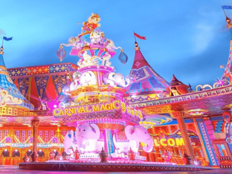 Carnival magic show: A vibrant night scene at Carnival Magic in Phuket, showcasing colourful lights, decorative elephants, and a festive atmosphere.