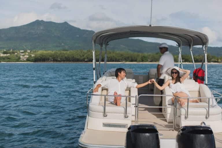 Phuket speedboat charter: A young couple enjoying a private speedboat charter on the serene waters of Phuket.