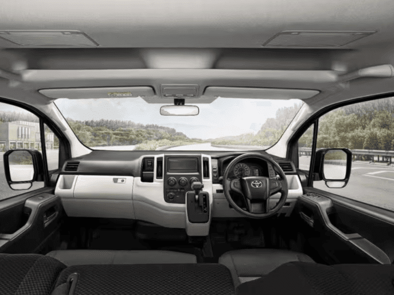 Modern and spacious dashboard of a Toyota commuter van for airport transfers.