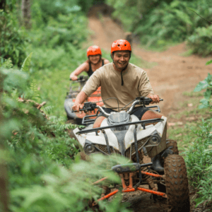 ATV adventure in phuket: Adventurous ATV ride in Phuket through lush green trails, showcasing two riders enjoying an exciting quad bike experience.