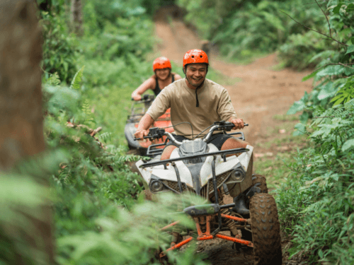 ATV adventure in phuket: Adventurous ATV ride in Phuket through lush green trails, showcasing two riders enjoying an exciting quad bike experience.