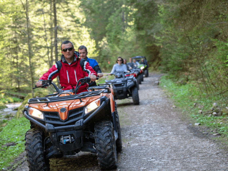 Group ATV ride in Phuket through scenic forest trails, highlighting an adventurous off-road experience.