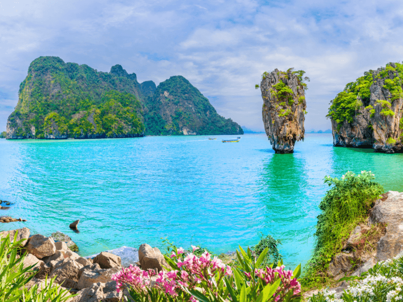 Stunning view of James Bond Island with turquoise waters and lush greenery, featuring the iconic limestone karst.