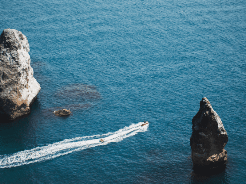 Jet Ski Riders Exploring Rock Formations in the Clear Blue Waters of Phuket