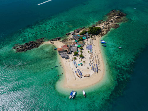 Khai island tour: A stunning aerial view of Khai Island, surrounded by turquoise waters, speedboats, and sandy beaches, showcasing the vibrant island paradise.