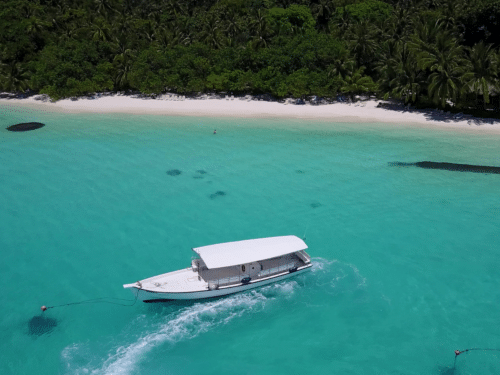 Khai Island Private Charter: A private charter boat anchored near the pristine white sand beaches and turquoise waters of Khai Island.