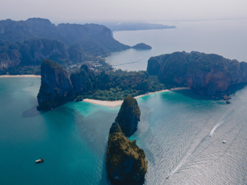 Krabi Island Private Charter: A stunning aerial view of Krabi Islands, showcasing turquoise waters, secluded beaches, and towering limestone cliffs.