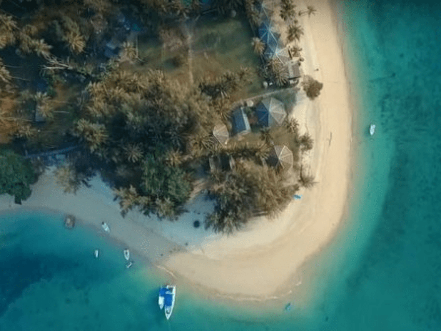 Naka Noi Island Private Charter: Aerial view of Naka Noi Island showcasing its pristine sandy beach, turquoise waters, and tropical palm trees.