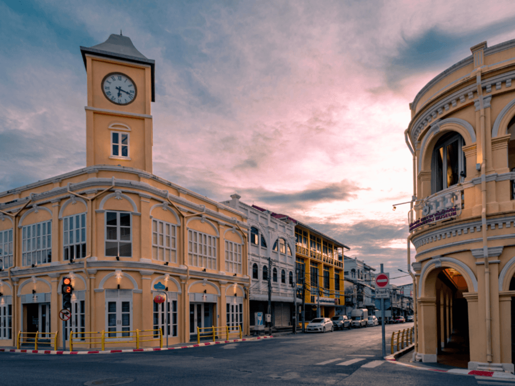 Phuket City Tours: Sunset view of historic Phuket Old Town clock tower and colonial architecture during a city tour. Experience the cultural and adventure tours in Phuket