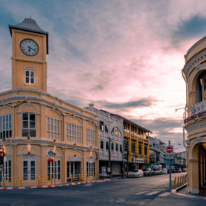 Phuket City Tours: Sunset view of historic Phuket Old Town clock tower and colonial architecture during a city tour. Experience the cultural and adventure tours in Phuket