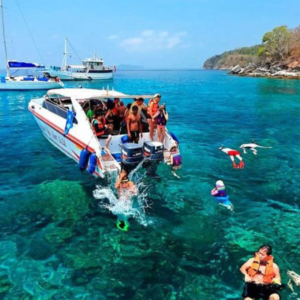 Racha Island Private Charter: A private speedboat with tourists enjoying snorkelling in the turquoise waters of Racha Island, surrounded by vibrant marine life.