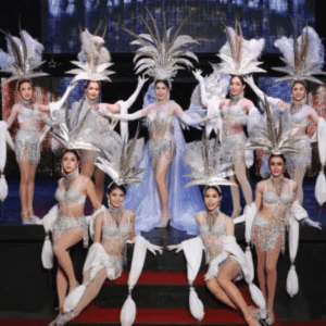 Simon Cabaret Show: Performers at the Simon Cabaret Show in Phuket, dressed in glamorous silver costumes with feathered headdresses, posing on stage.