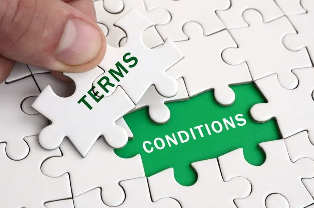 terms and conditions: Puzzle piece labeled "Terms" completing the gap labeled "Conditions," symbolizing agreement and compliance with terms.