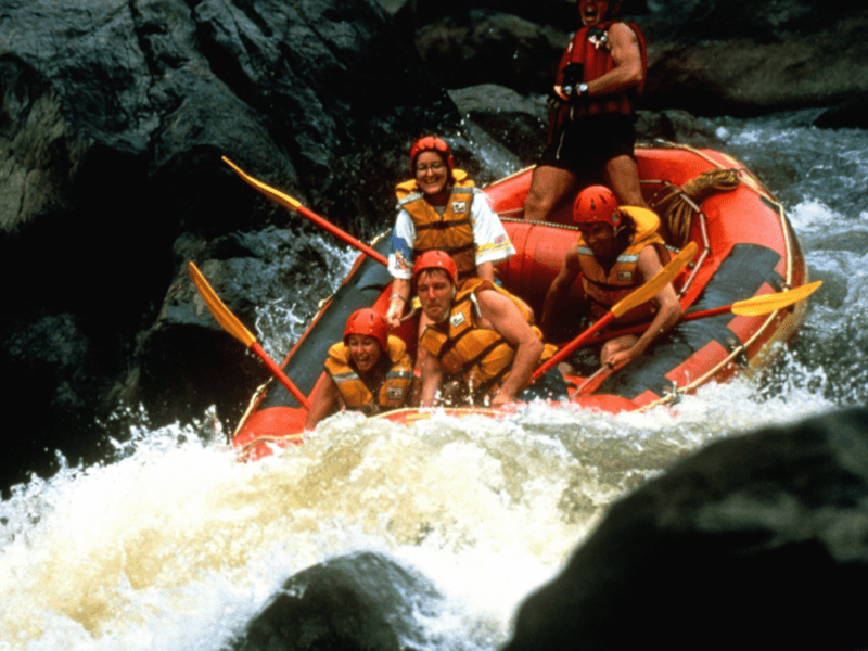 Adventurers navigating challenging rapids during a thrilling white water rafting experience in Phuket.