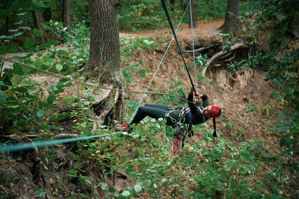 zipline in Phuket: Woman ziplining through lush jungle on Phuket adventure tour