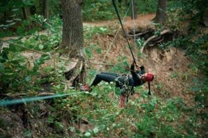 zipline in Phuket: Woman ziplining through lush jungle on Phuket adventure tour